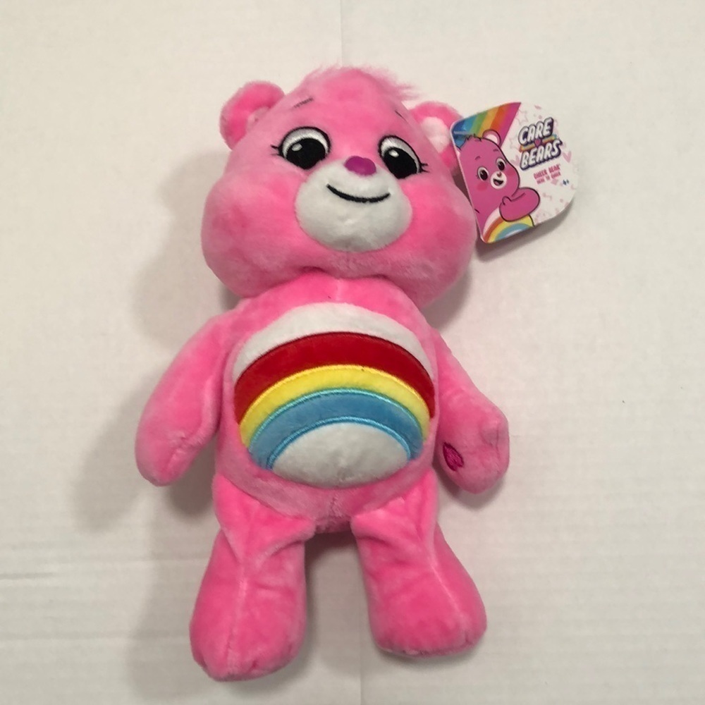 Care Bears Rainbow Bear in pink with hearts on hands and feet and ear tag
